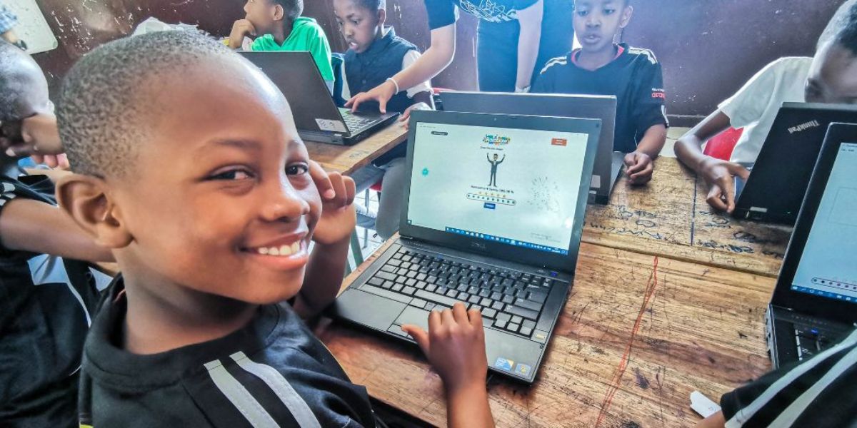 A boy is smiling while improving his maths skills using iRainbow.