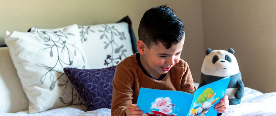 A child reading a book to improve their analytical reasoning