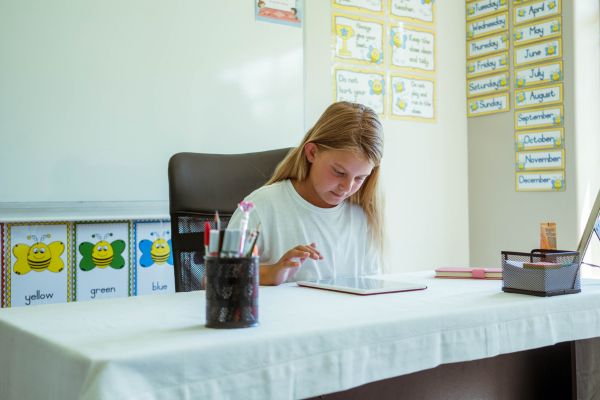 A student is reading in a classroom.