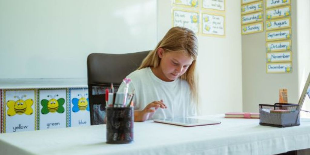 A student is reading in a classroom.