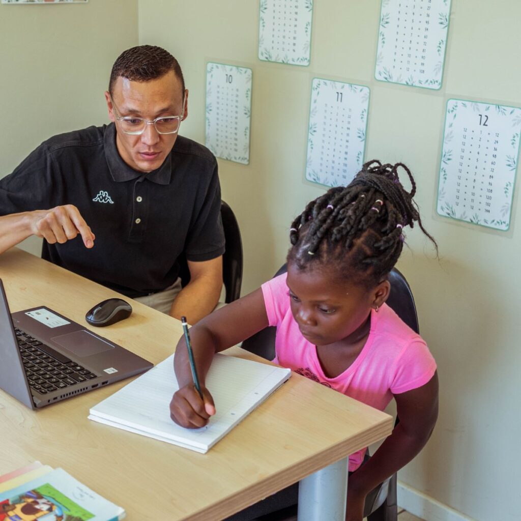 A teacher helping a learner with how to make a study plan