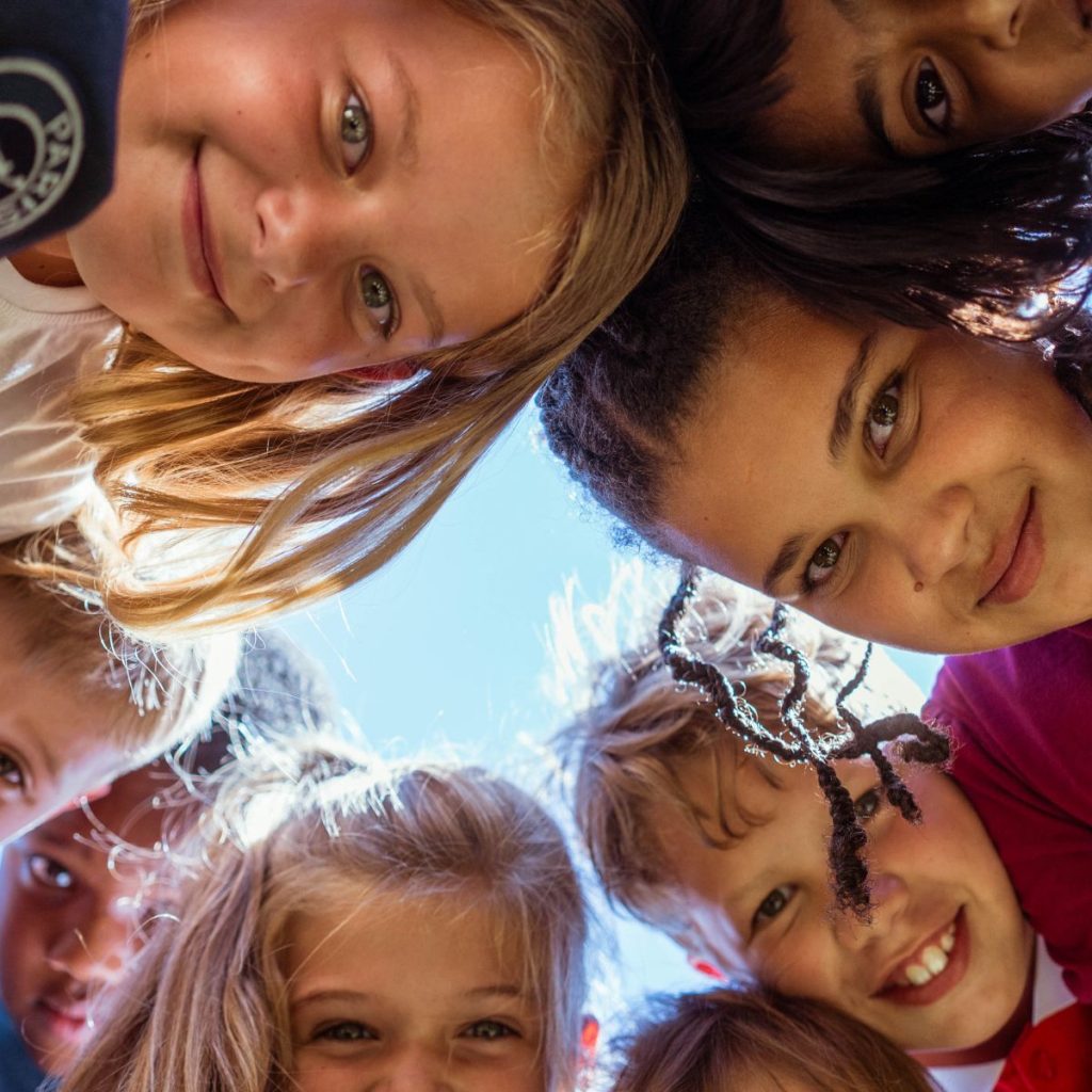 Children learning to improve their English by speaking in English while looking down