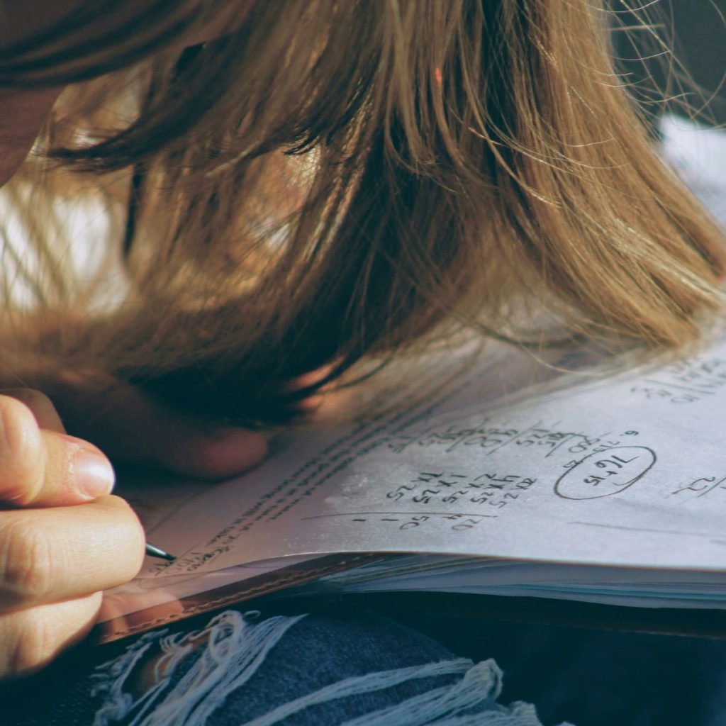 A young girl working on her Math's homework for school
